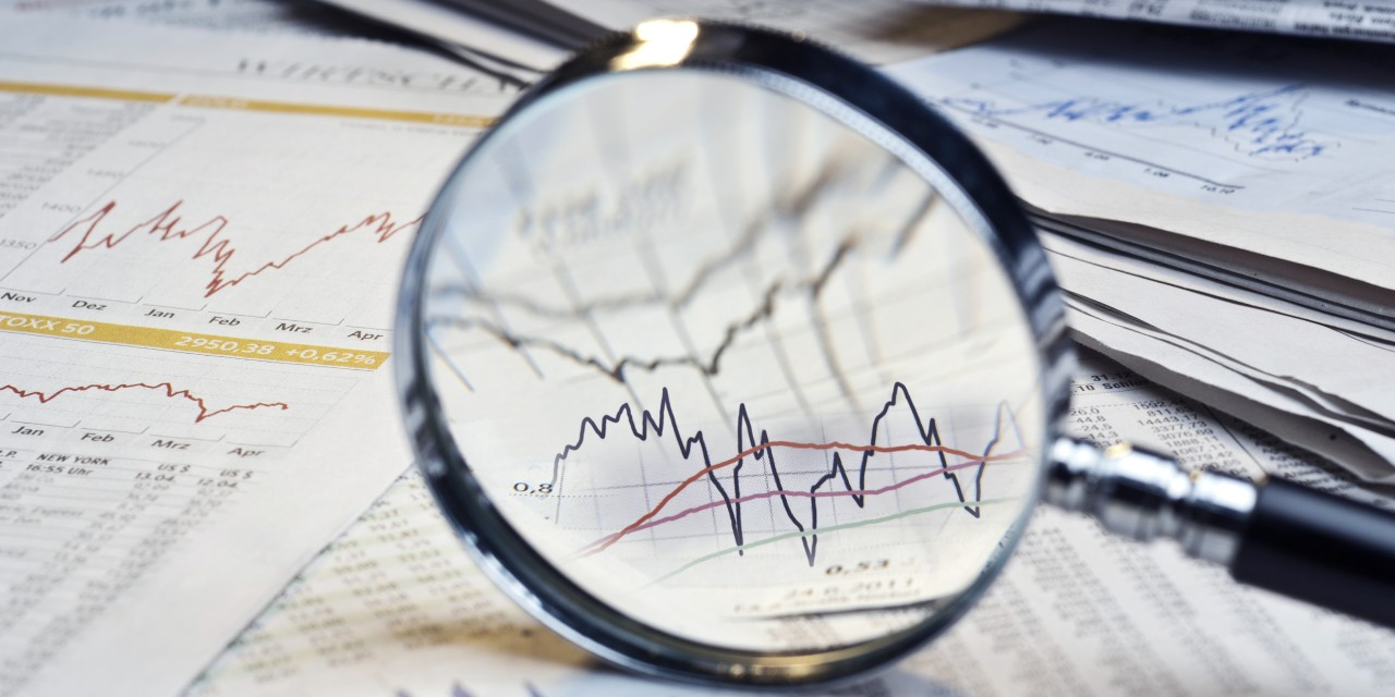 Stock chart viewed through a magnifying glass.