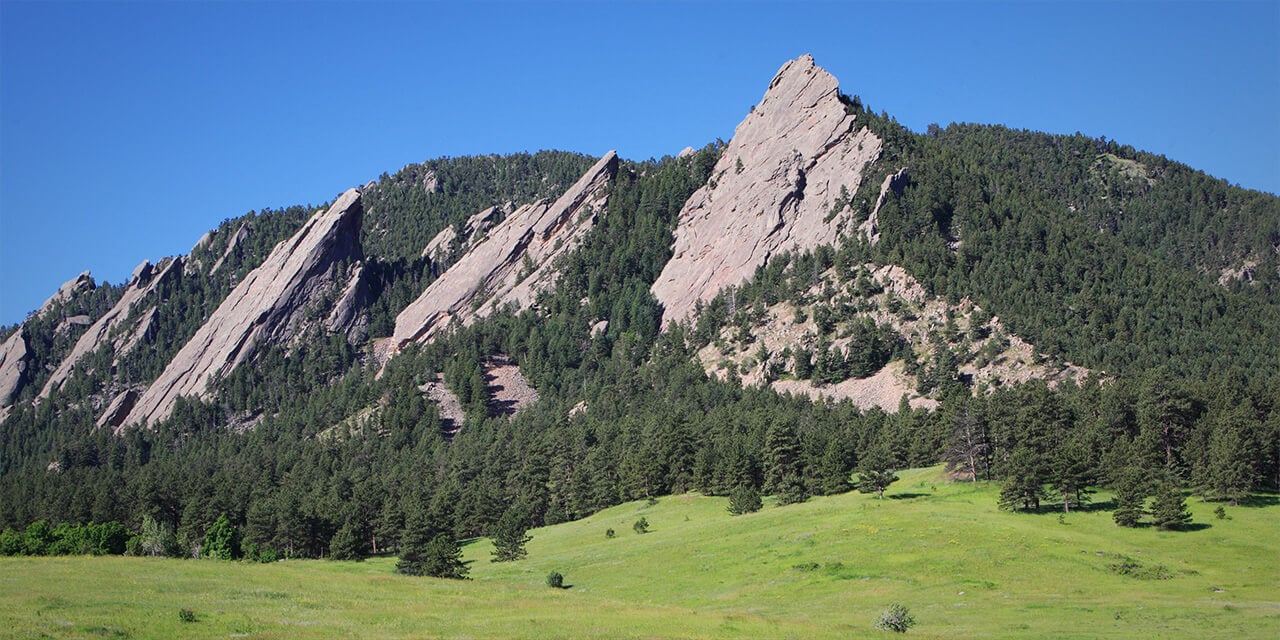 Landscape photo of the Flatirons during summer